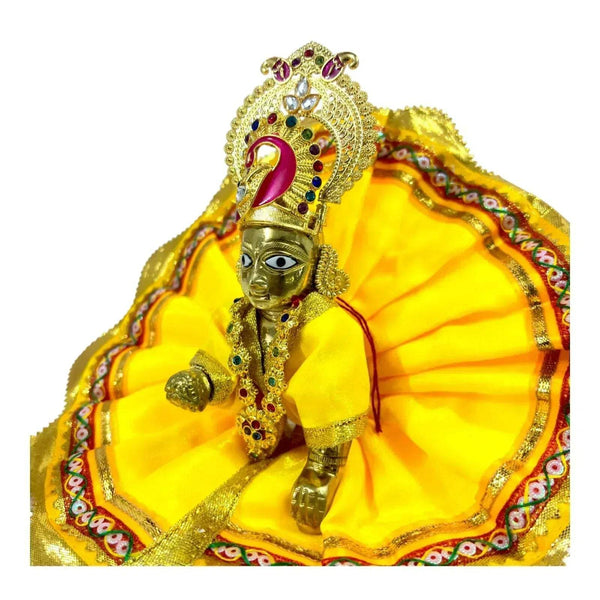 Gold jeweled headpiece and neck jewelry worn on a decorated figure with red and blue stones
