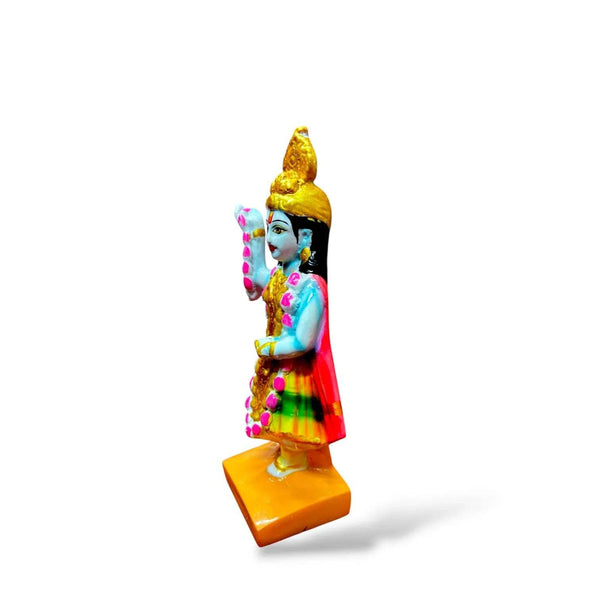 Profile blue-skinned goddess statue with gold crown and garland beads, red skirt, yellow base