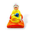 Small seated idol front view with white face, yellow robe, and blue sash on red base