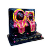 Marble dust idol statue with two seated figures in pink and yellow accents on black base