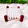 Wooden char pai palang with white woven seat and gold trim, red legs