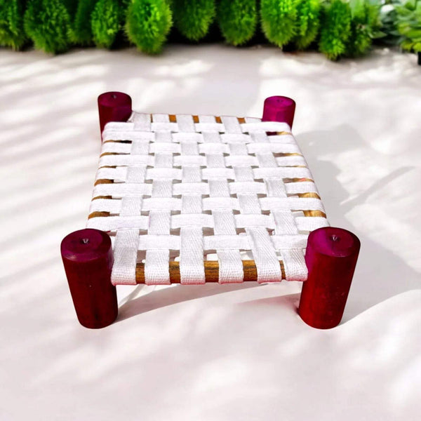 Wooden char pai palang with white woven seat and gold trim, red legs