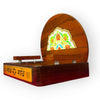 Wooden devotional throne with arched back and colorful center artwork; side view