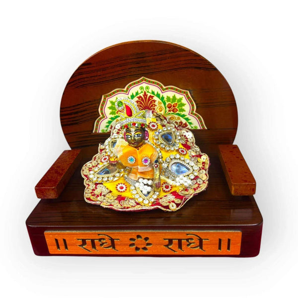 Wooden devotional throne holding a decorated Krishna idol on the front base