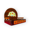 Wooden devotional throne with arched back and colorful center artwork; side view