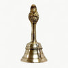 Brass pooja bell with Garuda-style deity finial, narrow handle, and flared rim