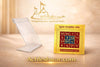 Acrylic stand holding a gold yantra card beside a boxed gold yantra