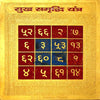 Golden yantra plaque with red grid cells and blue number symbols