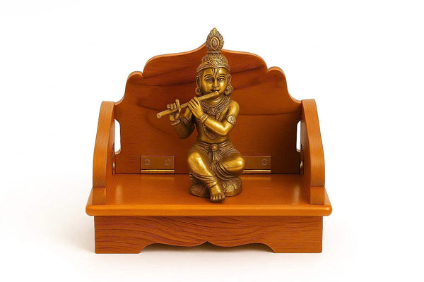 Wooden Bal Gopal singhasan with golden Krishna figurine on front platform