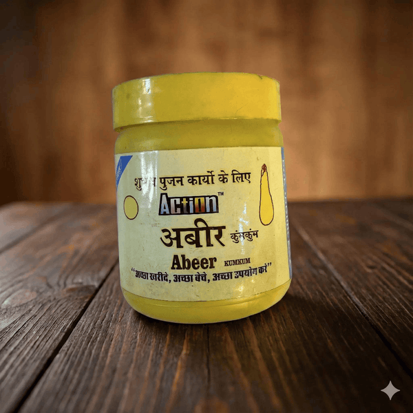 Action Abeer kumkum powder jar on wooden surface, yellow lid and front label