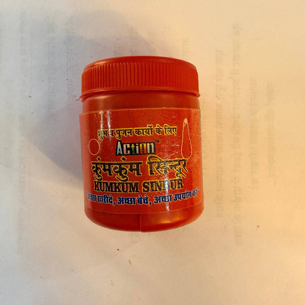 Red kumkum sindur powder jar with ribbed orange cap, front label visible.