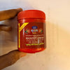 Lal sindur powder jar with red lid and side text label held in hand