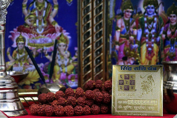 Gold-plated yantra plaque with lion emblem and Hindi lettering, in a protective box