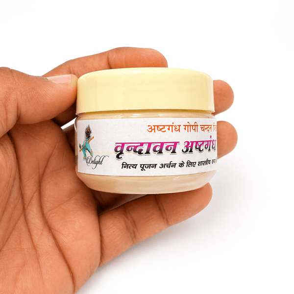 Tilak powder jar with cream lid held in hand, visible front label for pooja rituals