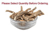 Dried herbal root pieces in a clear metal bowl