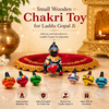 Small wooden chakri spinning top decor set with painted mini tops and Krishna figure
