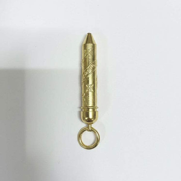 Gold-toned cylindrical pichkari accessory with engraved pattern and hanging loop