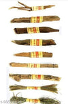 Hawan samidha wood sticks with red-yellow labels, stacked with bundled dried grass