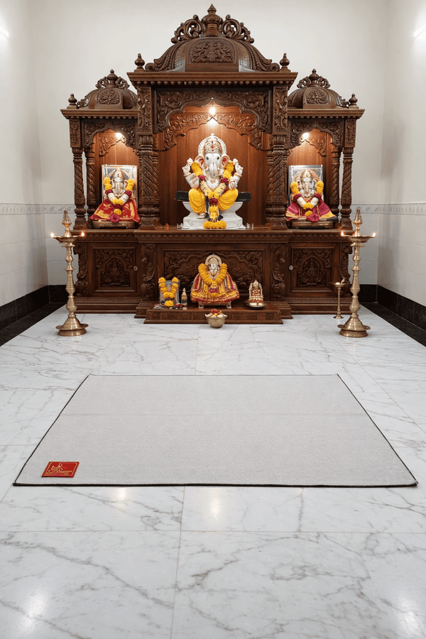 Light beige woolen meditation mat laid on the floor in a prayer area