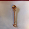Ornate copper pooja spoon with round bowl and bead-textured handle, pointed end