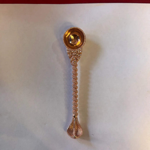 Ornate copper pooja spoon with round bowl and bead-textured handle, pointed end