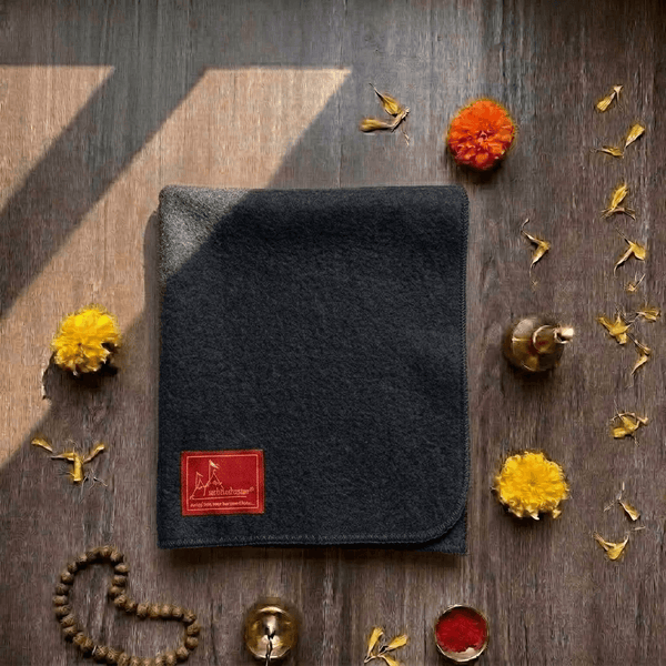 Black woolen meditation mat with red label patch and rounded corners