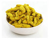 Yellow turmeric rhizome pieces in a white bowl