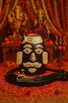 Decorative Shiva face ornament with crescent moon, gold trim on black base, temple puja set piece