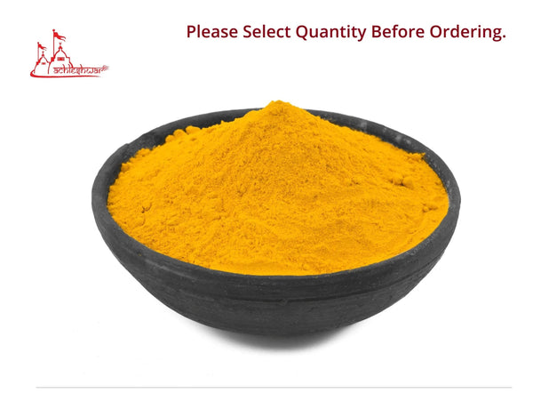 Turmeric powder filled in a dark bowl