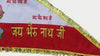 Red triangular temple flag with gold border and Hindi script