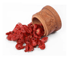 Javitri mace spice with red arils beside a carved terracotta container