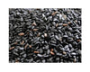 Black sesame seeds close-up with light specks