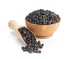 Black peppercorns in wooden bowl with measuring scoop