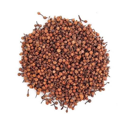 Pile of dried brown spice buds with stems, whole and loose