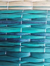 Braided darbha grass mat in teal blue with white woven ties close-up
