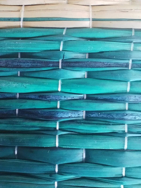Braided darbha grass mat in teal blue with white woven ties close-up