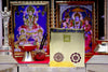 Golden Laxmi Ganesh yantra card on clear stand with circular and triangle symbols