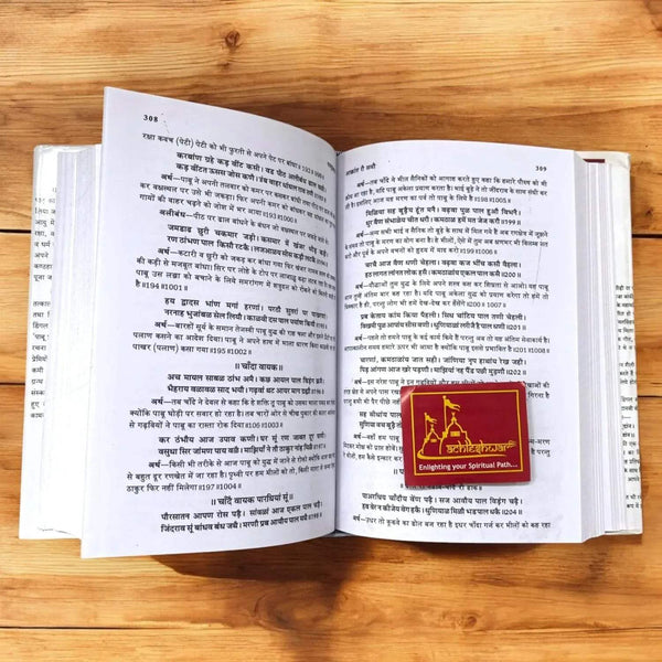 Open religious book with Hindi text and small red cover image inset on right page