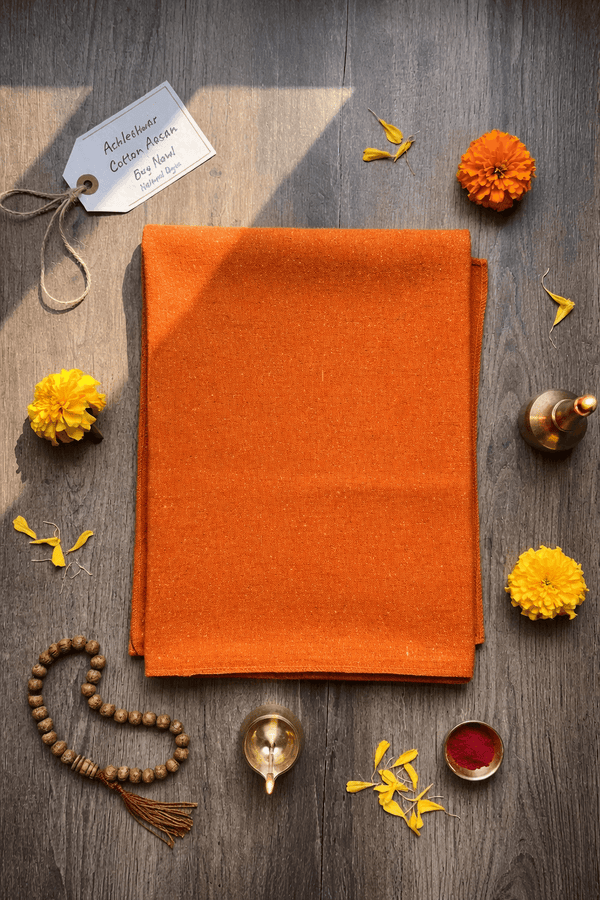 Orange woolen aasan meditation mat folded rectangle, with neat edges and smooth texture.