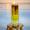 Kesar attar glass bottle with gold cap and greenish-yellow liquid