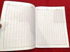 Open writing notebook with grid-lined pages and ruled margins