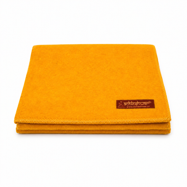 Yellow wool meditation mat with stitched border and small brand patch