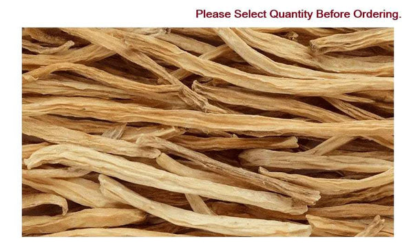 Satavari dried roots, long tan strips piled close-up