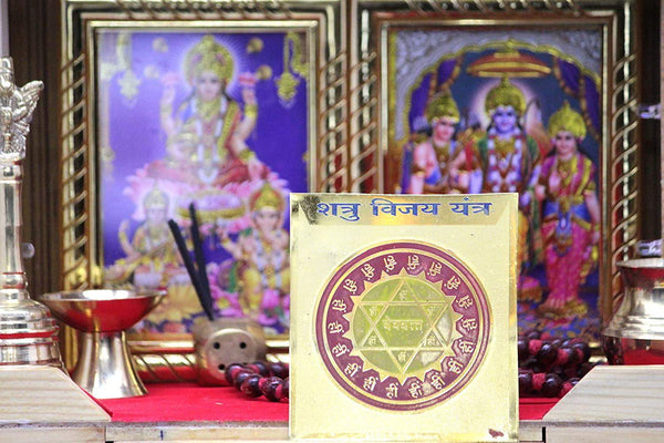 Shatru Vijay yantra card with metal stand, gold and red geometric seal