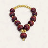 Maroon sandalwood mala bracelet with gold beads and small hanging bell