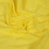 Yellow cotton gamcha fabric drape with soft woven texture, no stripes visible