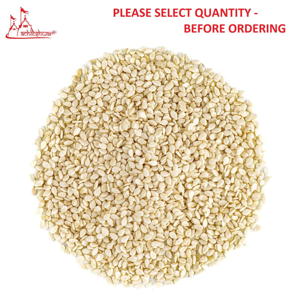 White sesame seeds in a heap, off-white kernels