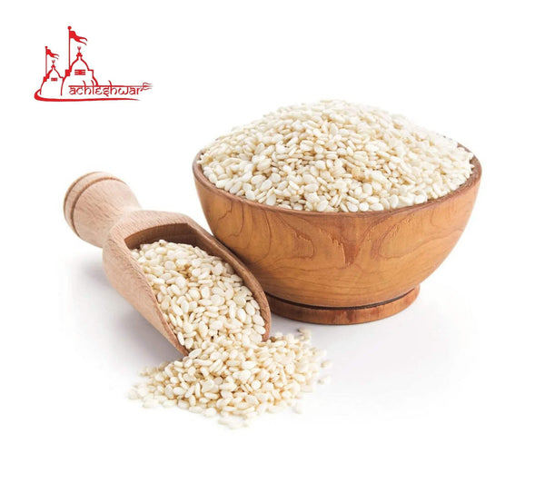White sesame seeds in wooden bowl and scoop, off-white kernels