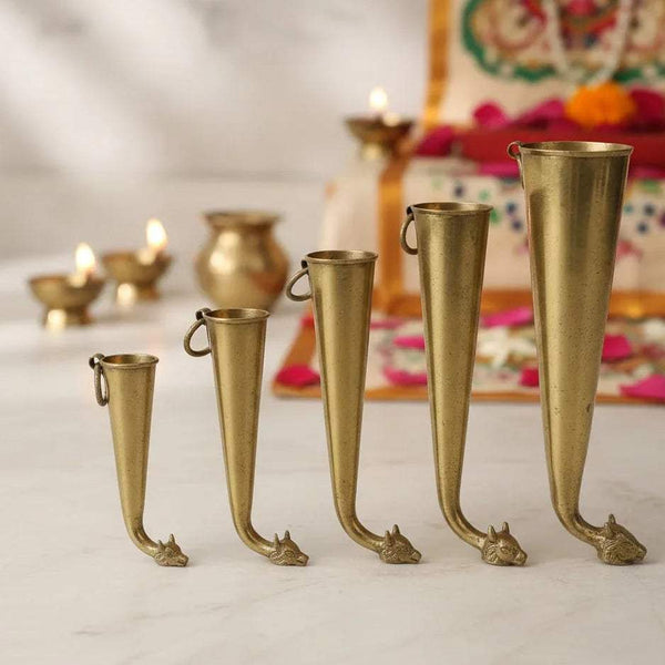 Brass gaumukhi shringi set of five, cone cups with loop handles and decorative feet