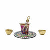 Krishna printed plate with matching pichkari bucket and two gold bowls